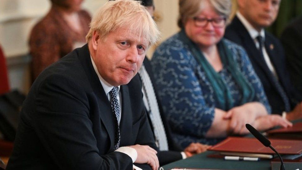 Boris Johnson is fighting for political survival after two of his top ministers attacked his leadership and resigned.
