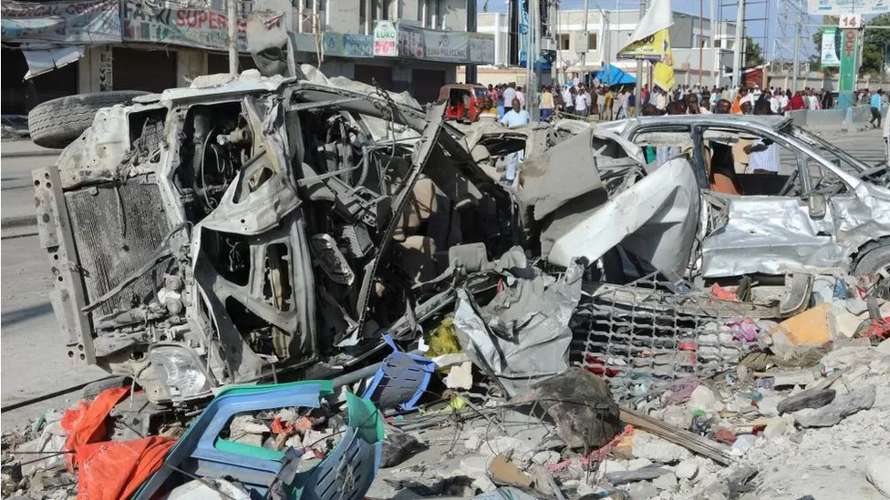 Twin car bomb explosions near a busy junction in Somalia’s capital, Mogadishu, killed at least 100 people, President Hassan Sheikh Mohamud says.