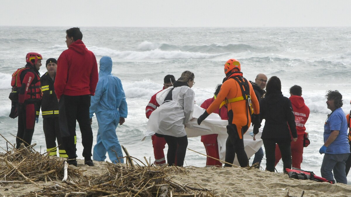 At least 59 migrants, including 12 children, have died and dozens more are feared missing after their boat sank in rough seas off southern Italy.