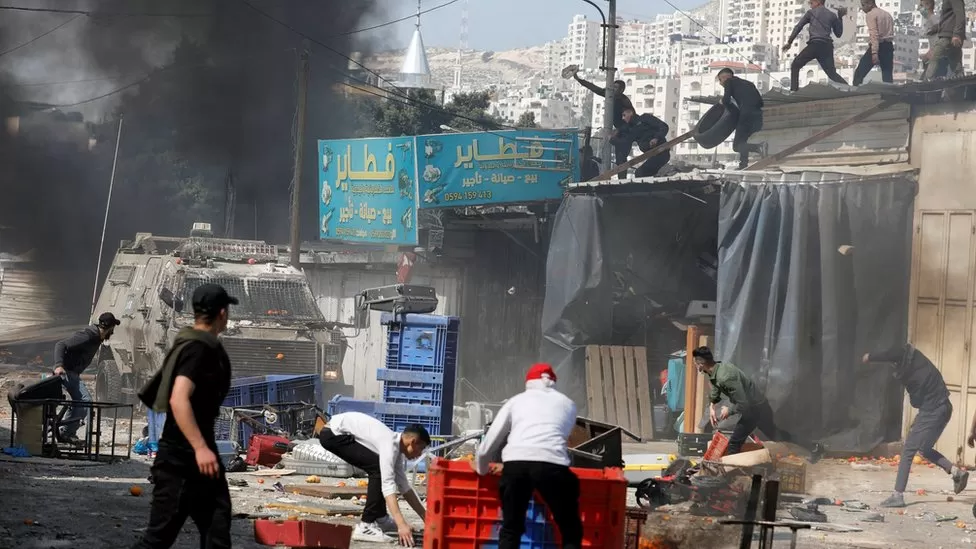 Israeli troops have killed at least 11 Palestinians and wounded dozens more during a raid in the occupied West Bank, Palestinian health officials say.
