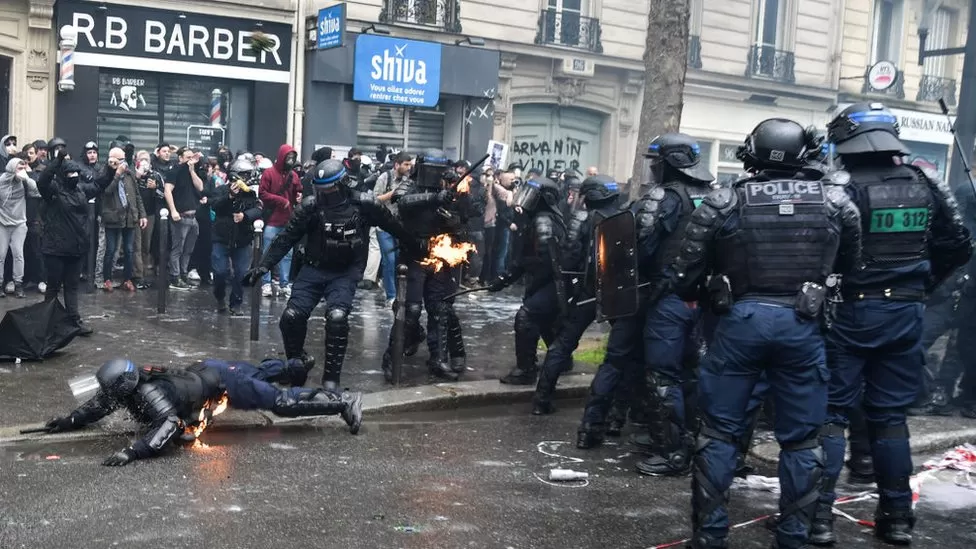 At least 108 police officers have been injured in clashes across France with protesters angry at pension reforms, the interior minister has said.